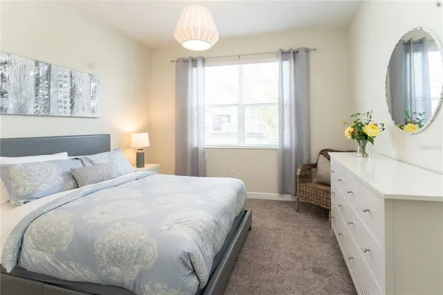 a view of swimming pool with seating area and tub in the background
