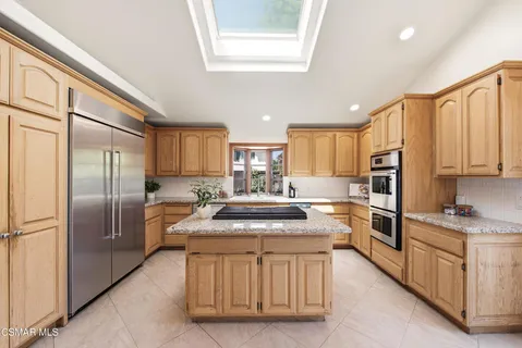 a kitchen with stainless steel appliances granite countertop a refrigerator sink and cabinets