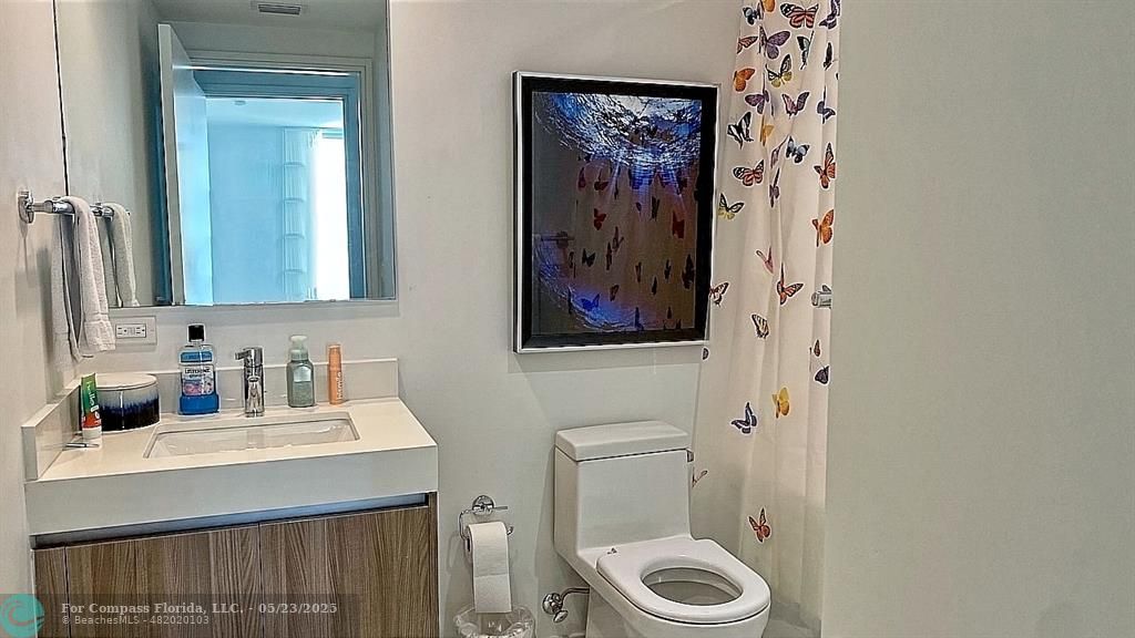 401 North Birch Road, Unit 415 Fort Lauderdale, FL 33304 - Photo 14 of 33 a bathroom with a toilet a sink and a mirror