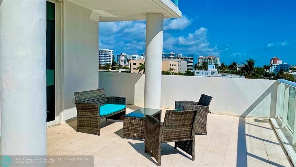 401 North Birch Road, Unit 415 Fort Lauderdale, FL 33304 - Photo 2 of 33 a balcony with table and chairs