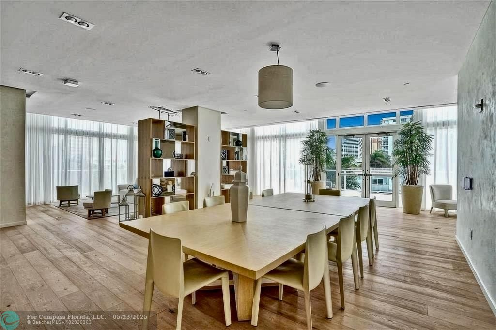 401 North Birch Road, Unit 415 Fort Lauderdale, FL 33304 - Photo 30 of 33 an open kitchen with dining table and chairs