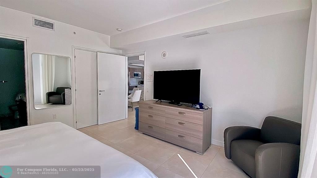 401 North Birch Road, Unit 415 Fort Lauderdale, FL 33304 - Photo 5 of 33 a hotel room with a bed and a television