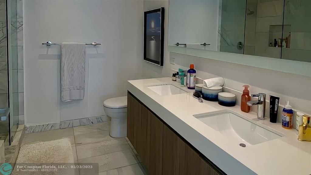 401 North Birch Road, Unit 415 Fort Lauderdale, FL 33304 - Photo 6 of 33 a bathroom with a sink toilet and shower