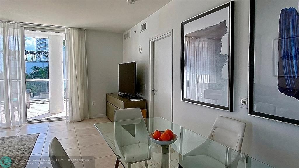 401 North Birch Road, Unit 415 Fort Lauderdale, FL 33304 - Photo 8 of 33 a living room with furniture a flat screen tv and a window