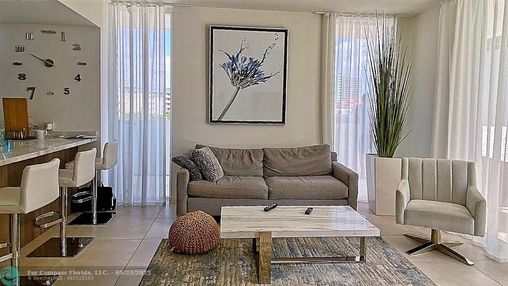 401 North Birch Road, Unit 415 Fort Lauderdale, FL 33304 - Photo 9 of 33 a living room with furniture and a window