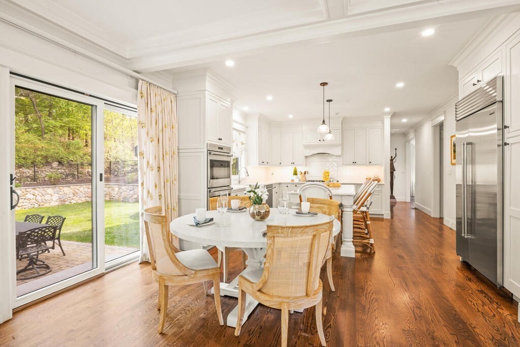 22 Richard Road Lexington, MA 02421 - Photo 12 of 42 a view of a dining room with furniture large windows and wooden floor