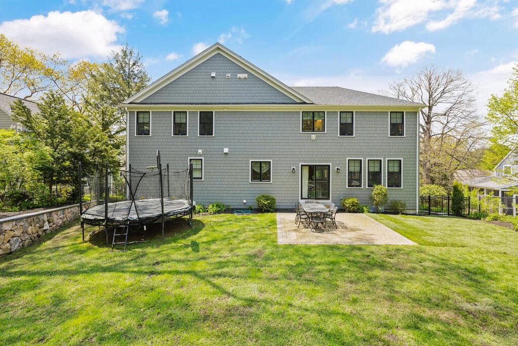 22 Richard Road Lexington, MA 02421 - Photo 40 of 42 a backyard of a house with table and chairs