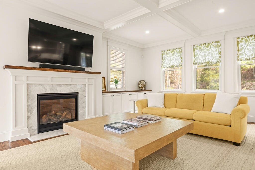 22 Richard Road Lexington, MA 02421 - Photo 8 of 42 a living room with furniture a flat screen tv and a fireplace