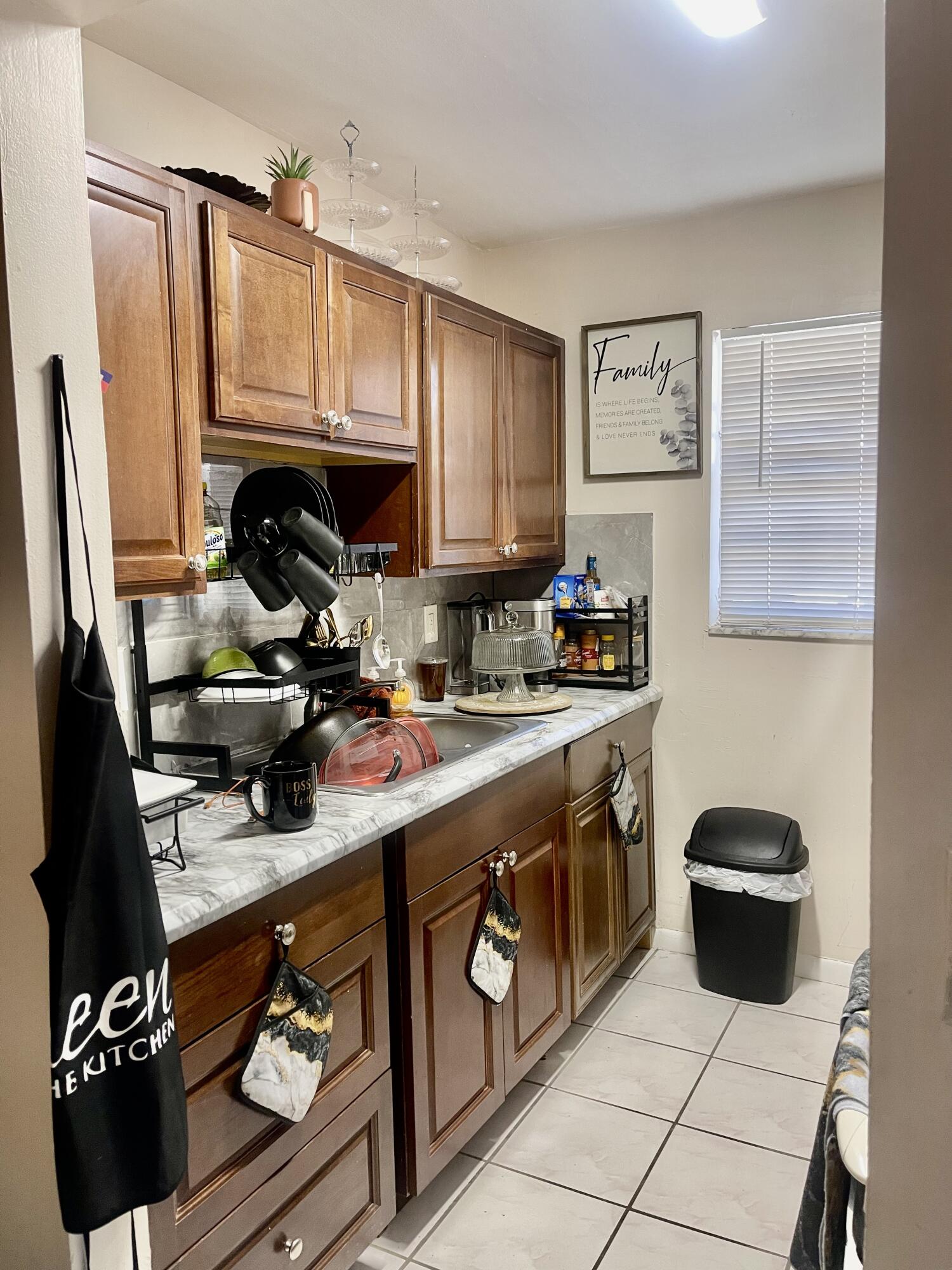 205 Northeast 3rd Street, Unit 110 Boynton Beach, FL 33435 - Photo 6 of 8 a kitchen with a sink a stove and a refrigerator