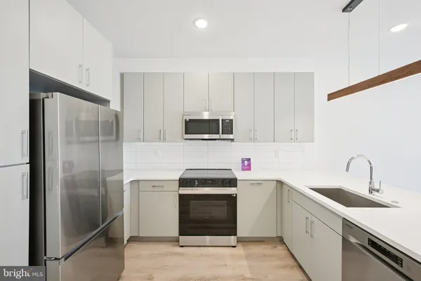 a kitchen with a sink appliances and cabinets