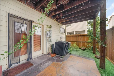 a view of a porch with furniture and floor to ceiling window