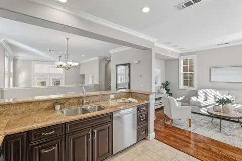 a spacious bathroom with a granite countertop sink and a mirror