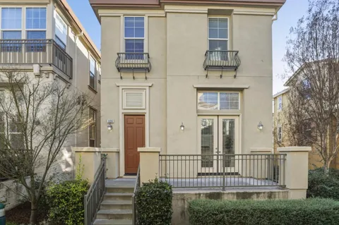 a view of a house with iron fence