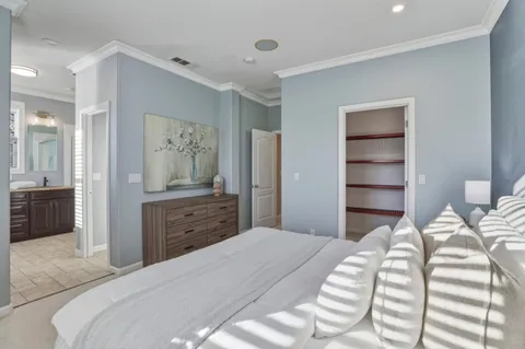 a bedroom with a bed and a chandelier