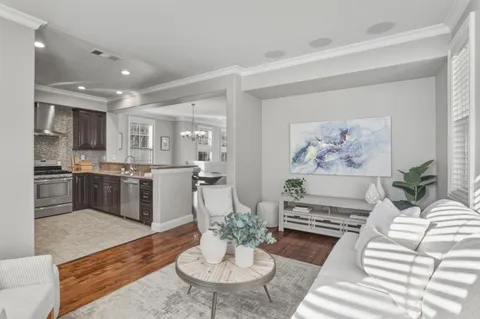 a living room with furniture kitchen and a table