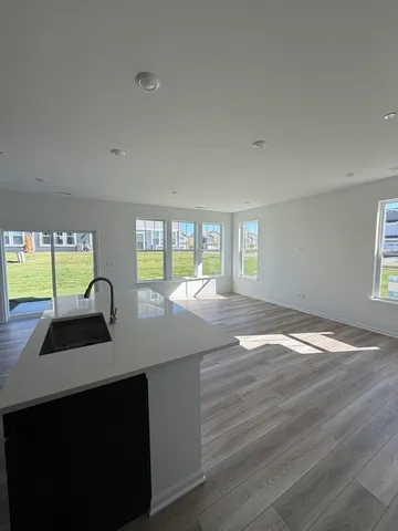 a kitchen with granite countertop a sink a stove and cabinets