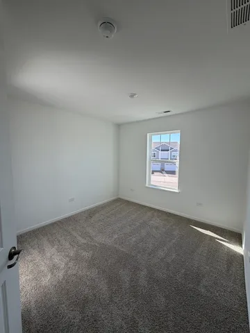 an empty room with a windows