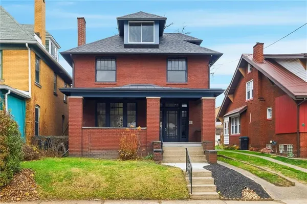 a front view of a house with a yard