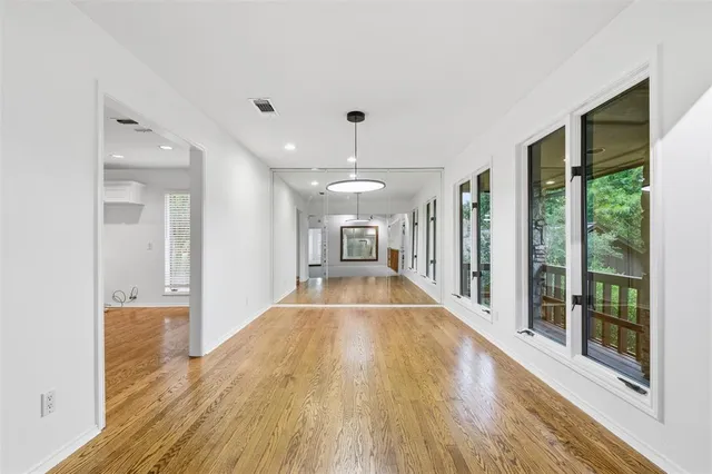 a view of a living room hardwood floor to ceiling window and wooden floor