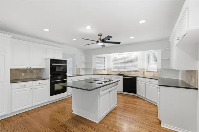 a kitchen with a stove a sink and a refrigerator