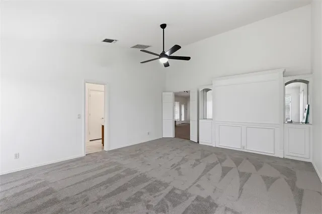 a view of a livingroom with a chandelier fan