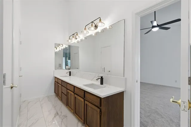 a bathroom with a double vanity sink and a mirror