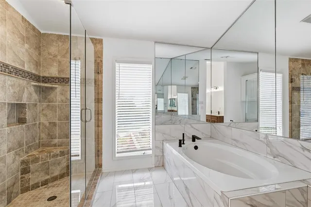 a bathroom with a bathtub and a shower