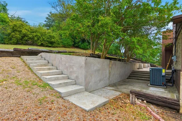 a view of a backyard with wooden fence