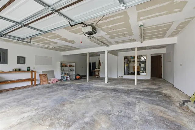a view of a hall with table and chairs in a room
