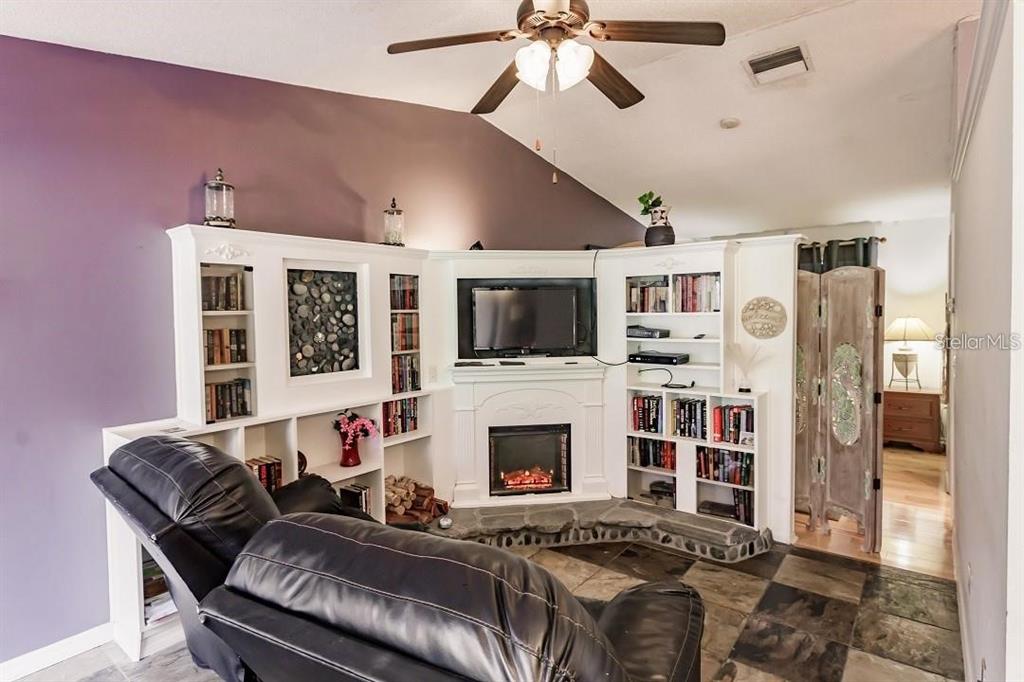 323 Bobby Jones Road, Unit 323 Sarasota, FL 34232 - Photo 5 of 10 a living room with furniture fireplace and flat screen tv