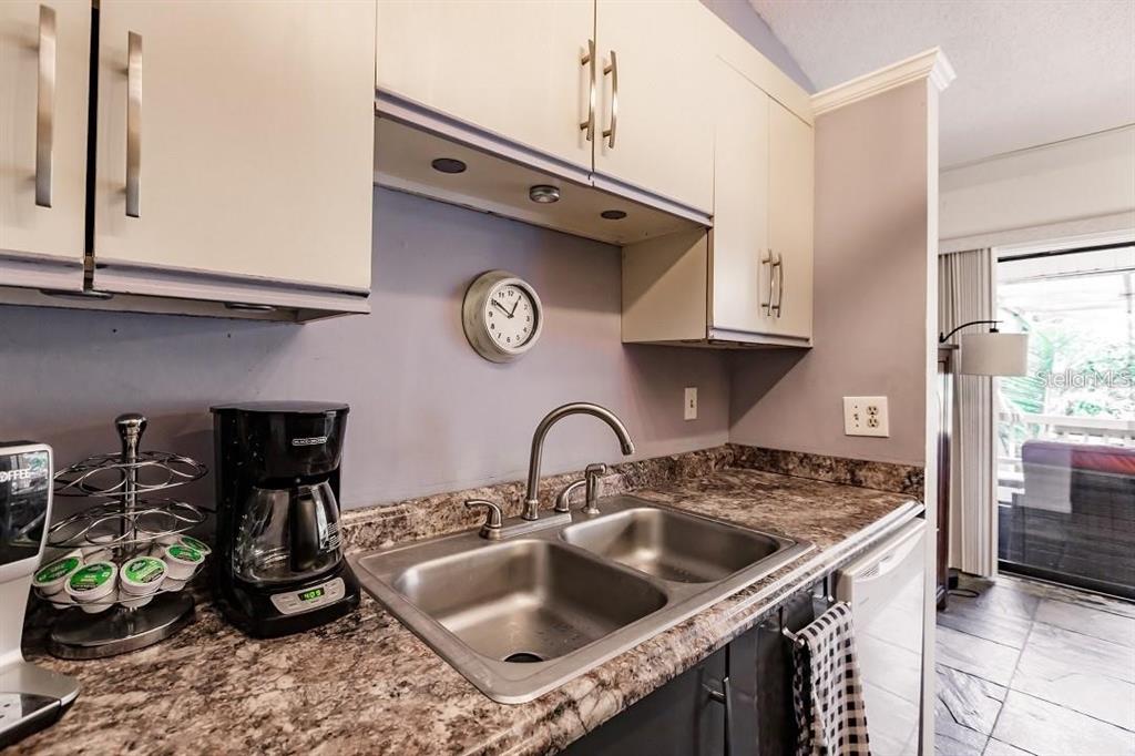 323 Bobby Jones Road, Unit 323 Sarasota, FL 34232 - Photo 7 of 10 a kitchen with a sink and a stove top oven