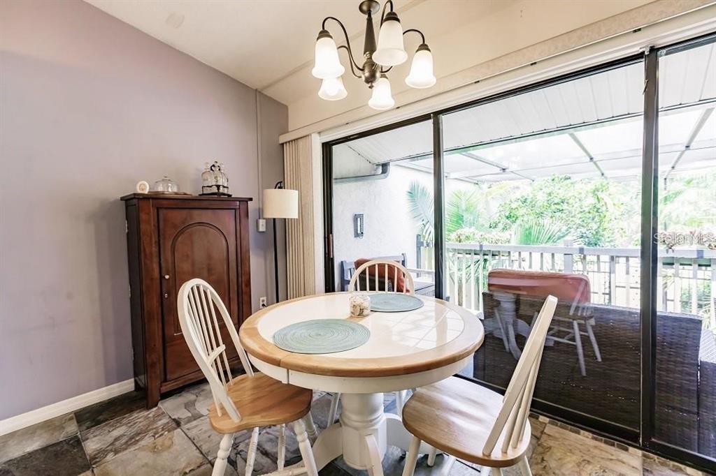 323 Bobby Jones Road, Unit 323 Sarasota, FL 34232 - Photo 8 of 10 a view of a dining room with furniture window and outside view