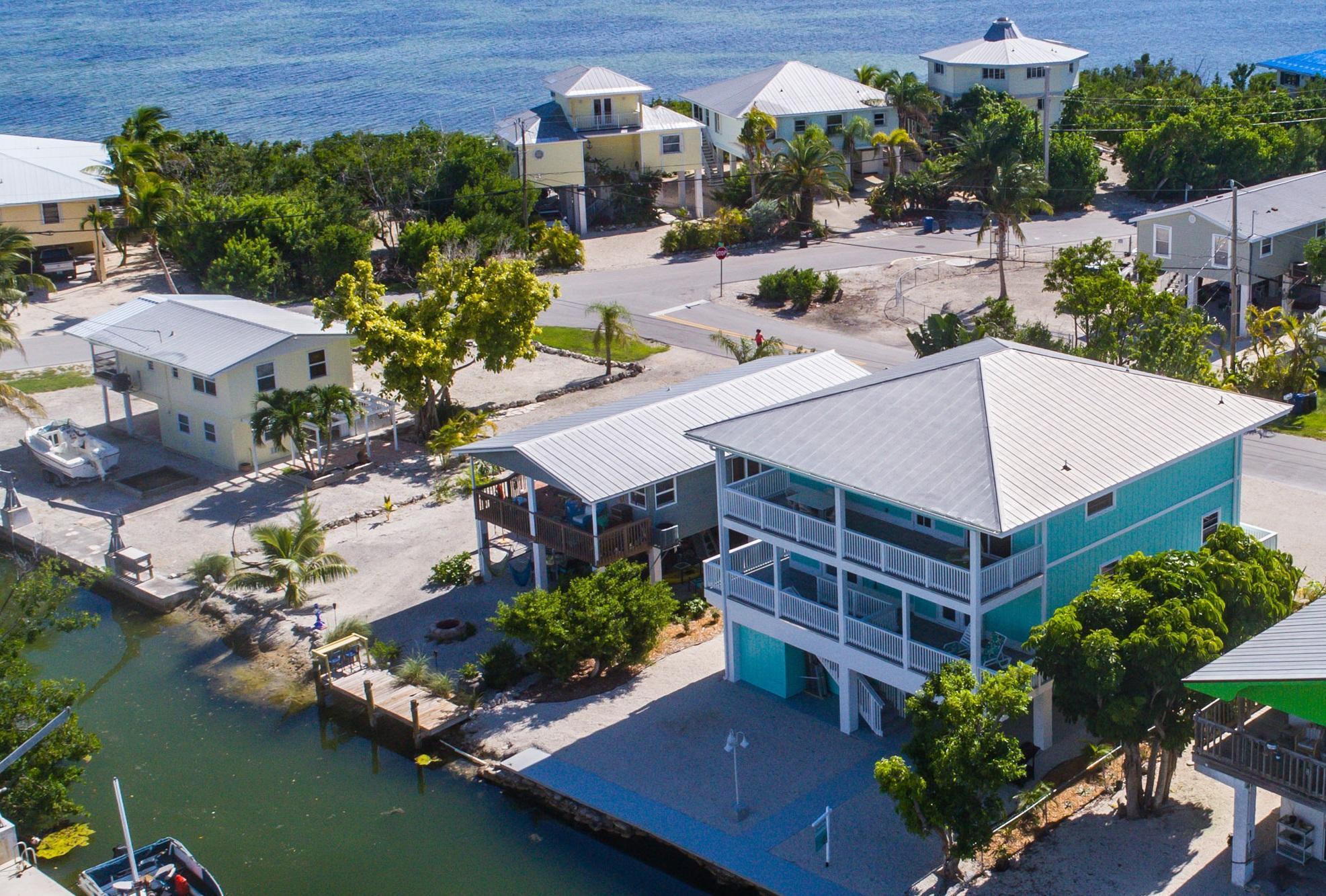 an aerial view of a house with a garden and lake view