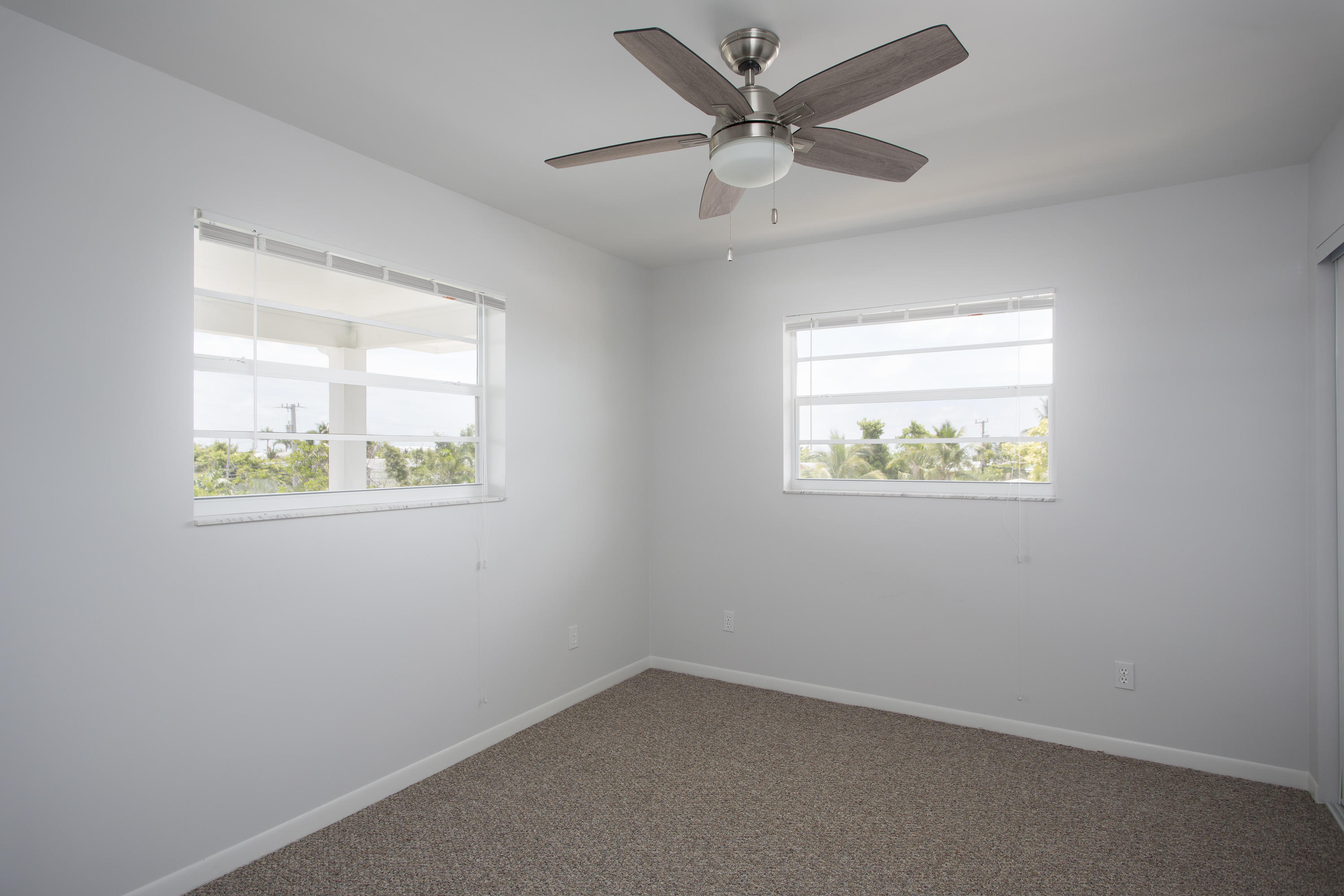165 Cutlass Lane Cudjoe, FL 33042 - Photo 19 of 30 an empty room with a window and a ceiling fan