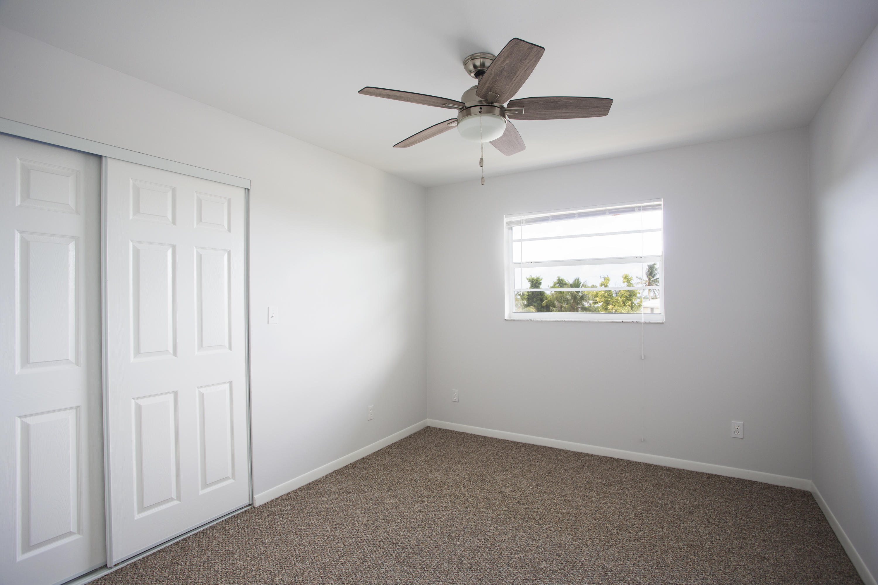 165 Cutlass Lane Cudjoe, FL 33042 - Photo 20 of 30 an empty room with a window and a ceiling fan