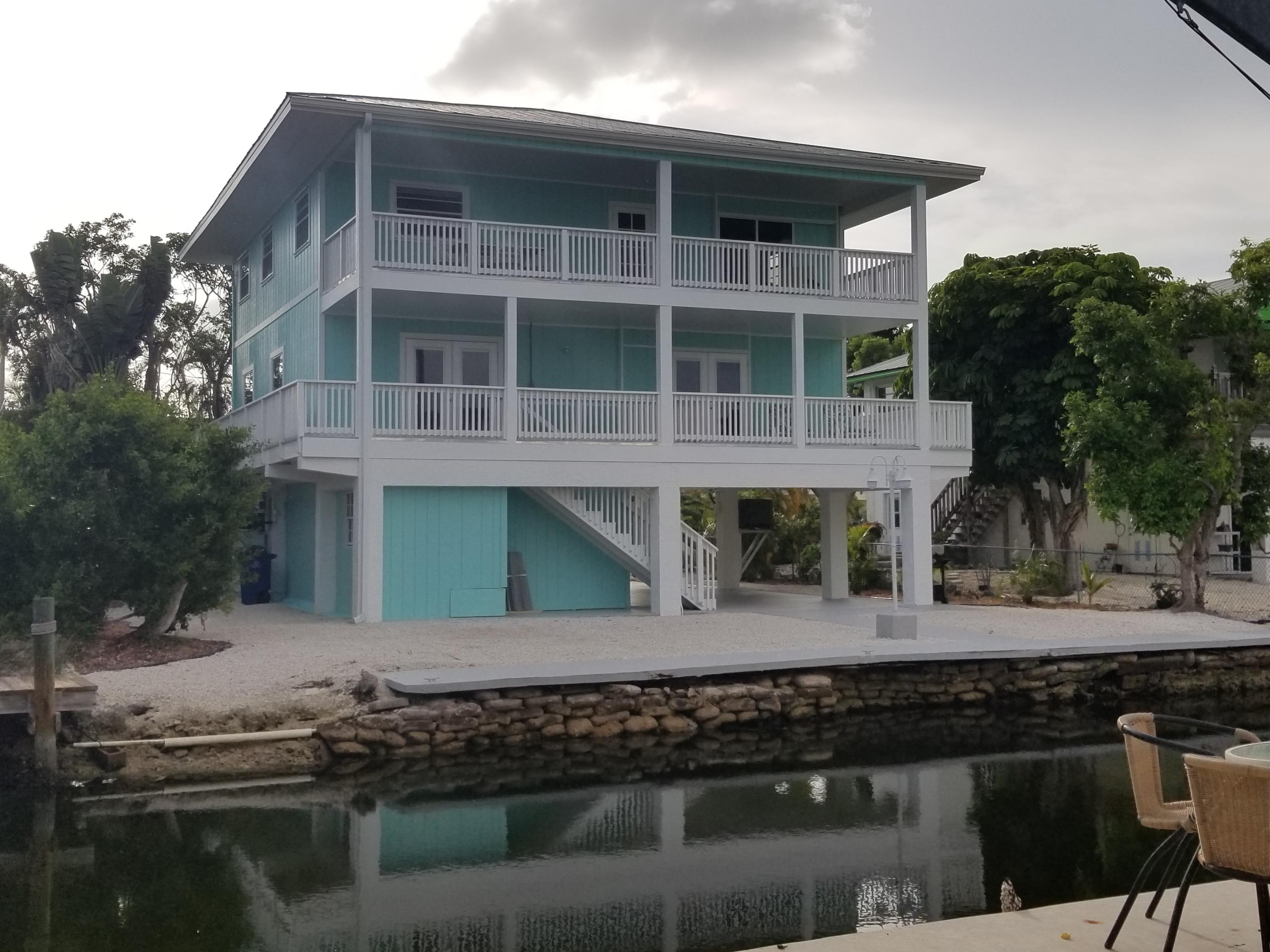 165 Cutlass Lane Cudjoe, FL 33042 - Photo 27 of 30 a front view of a house with a yard