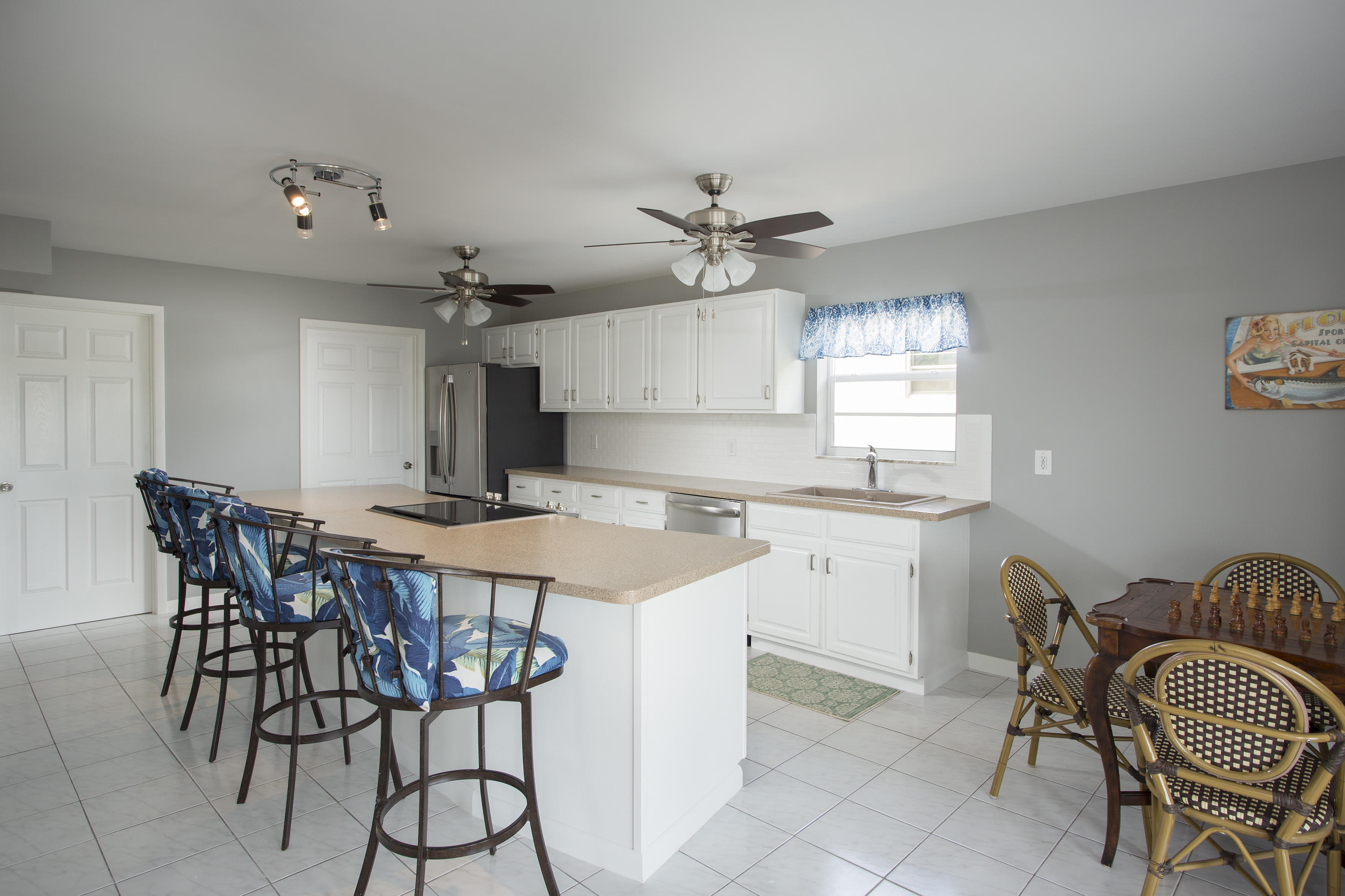 165 Cutlass Lane Cudjoe, FL 33042 - Photo 5 of 30 a kitchen with a table chairs and a refrigerator