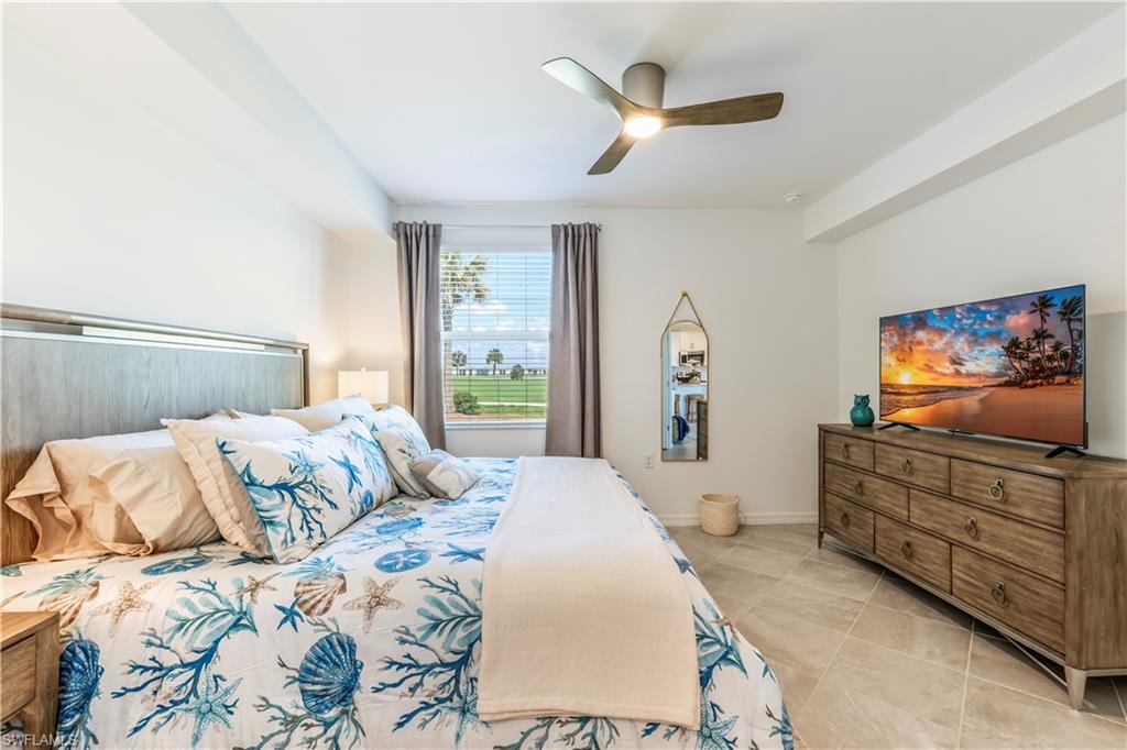 43985 Boardwalk Loop, Unit 2118 Punta Gorda, FL 33982 - Photo 12 of 32 a bedroom with a bed and a flat screen tv