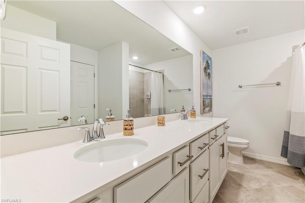 43985 Boardwalk Loop, Unit 2118 Punta Gorda, FL 33982 - Photo 14 of 32 a bathroom with a sink and a mirror