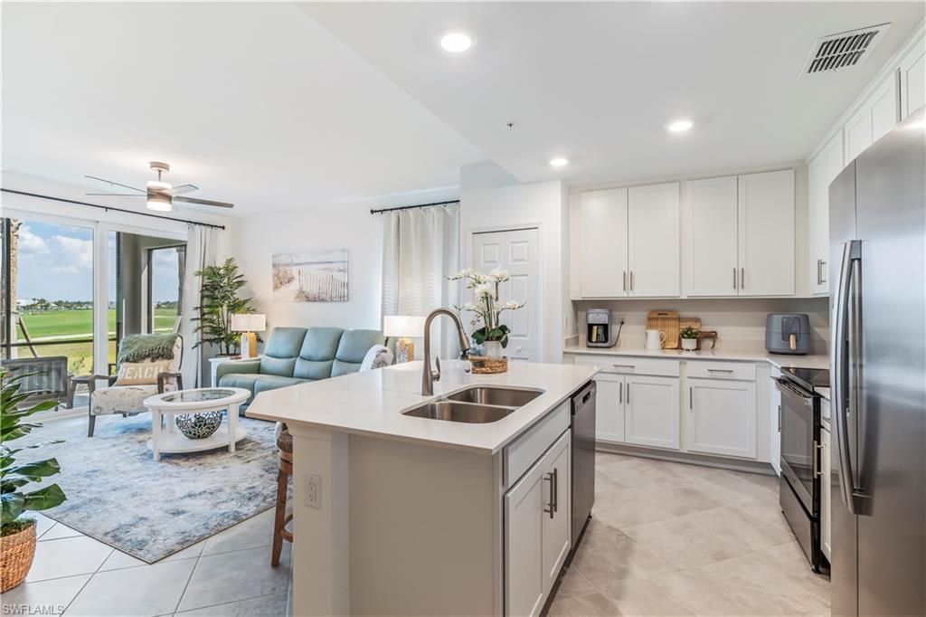43985 Boardwalk Loop, Unit 2118 Punta Gorda, FL 33982 - Photo 7 of 32 a kitchen that has a lot of white cabinets and stainless steel appliances