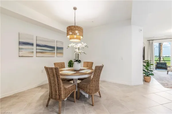 a view of a dining room with a table and chairs
