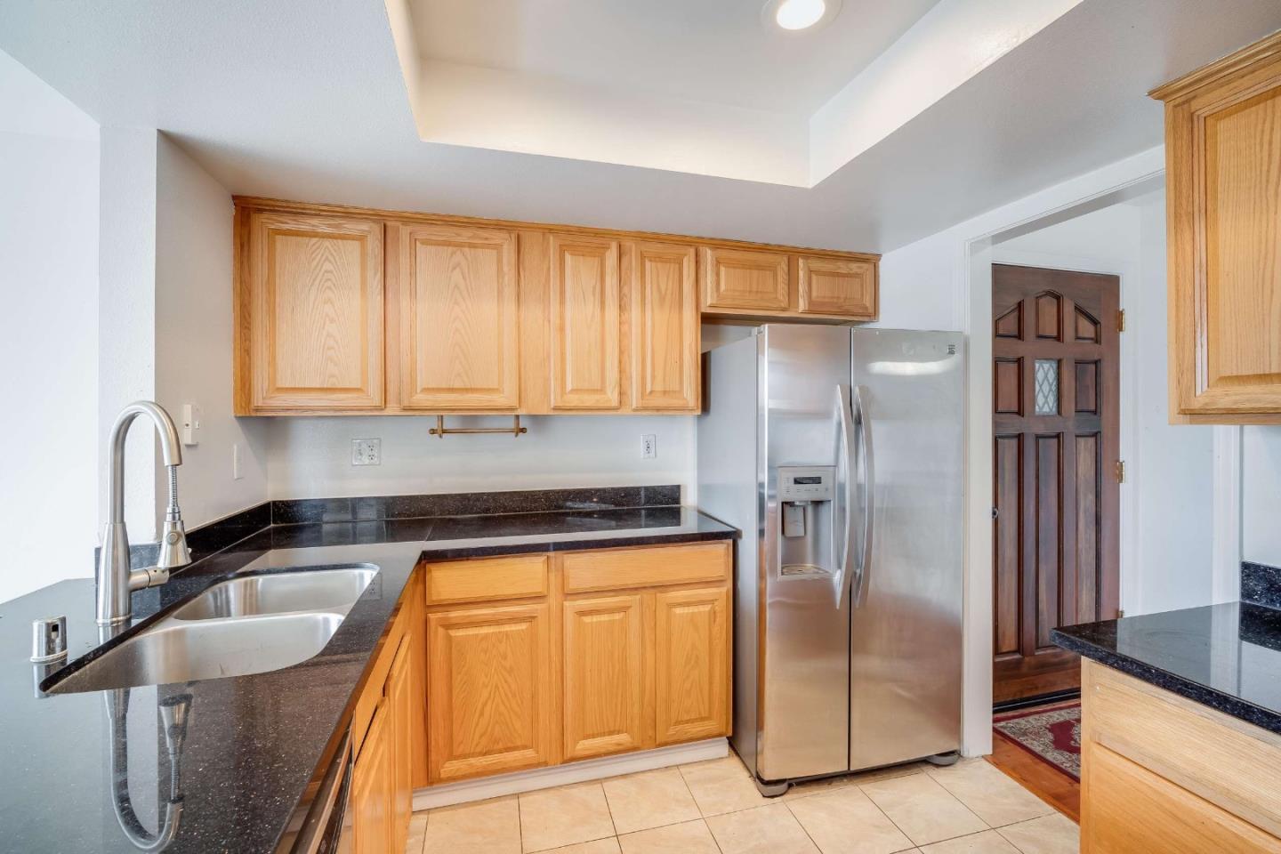 22135 Sevilla Road, Unit 47 Hayward, CA 94541 - Photo 12 of 37 a kitchen with granite countertop a refrigerator and a sink