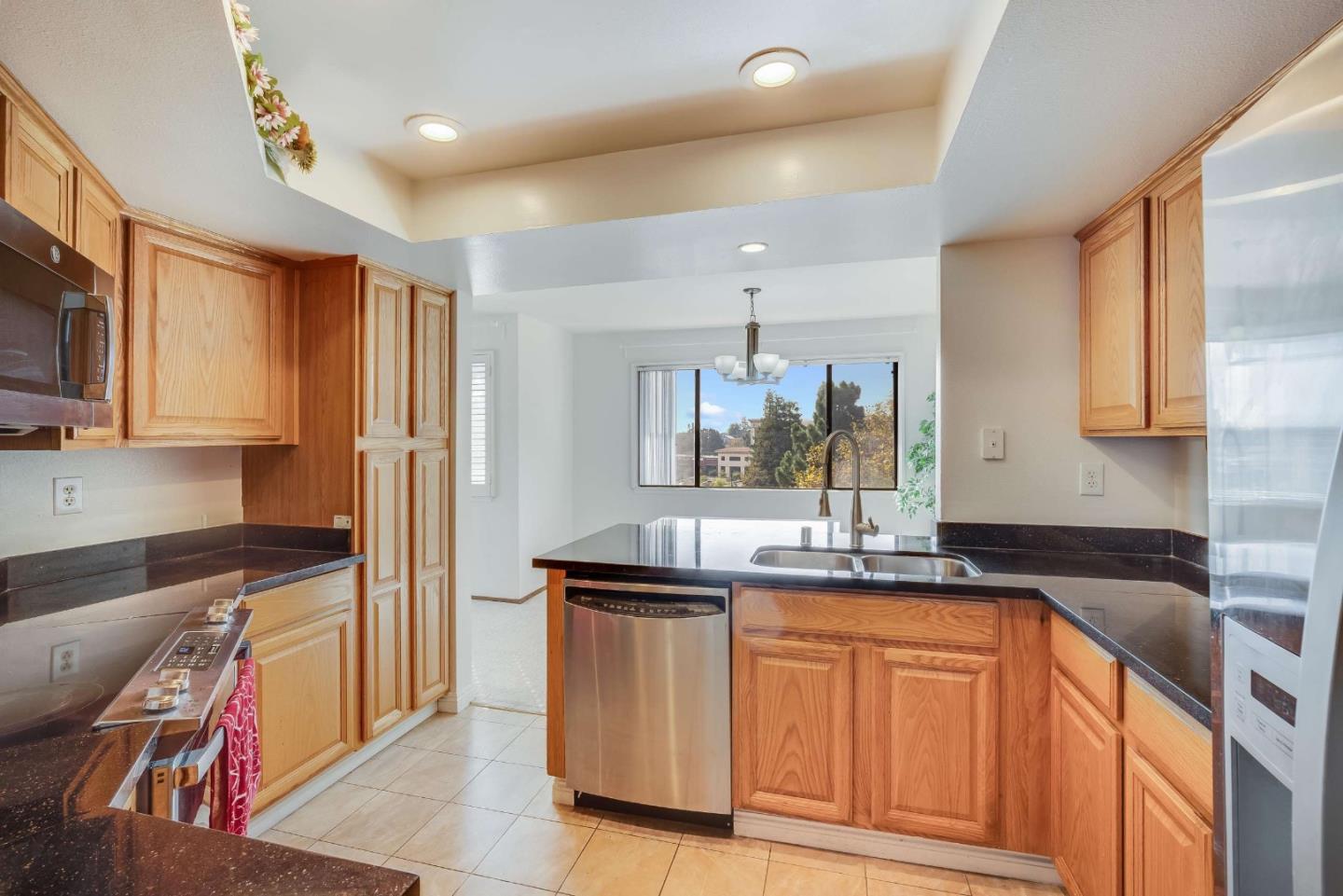 22135 Sevilla Road, Unit 47 Hayward, CA 94541 - Photo 13 of 37 a kitchen with granite countertop a sink and cabinets