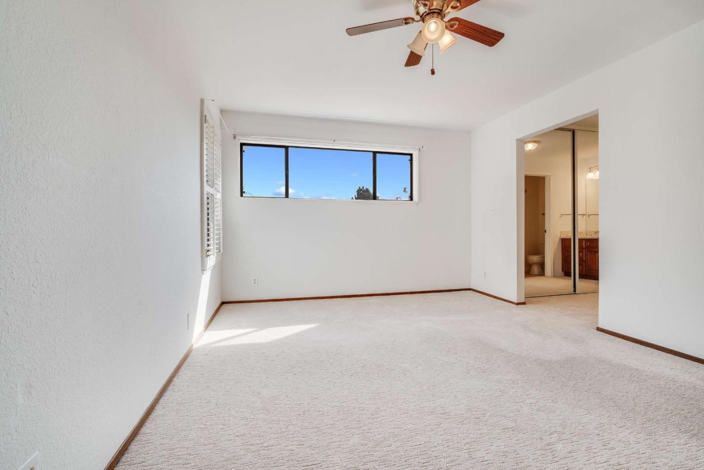 22135 Sevilla Road, Unit 47 Hayward, CA 94541 - Photo 20 of 37 an empty room with a ceiling fan and a window