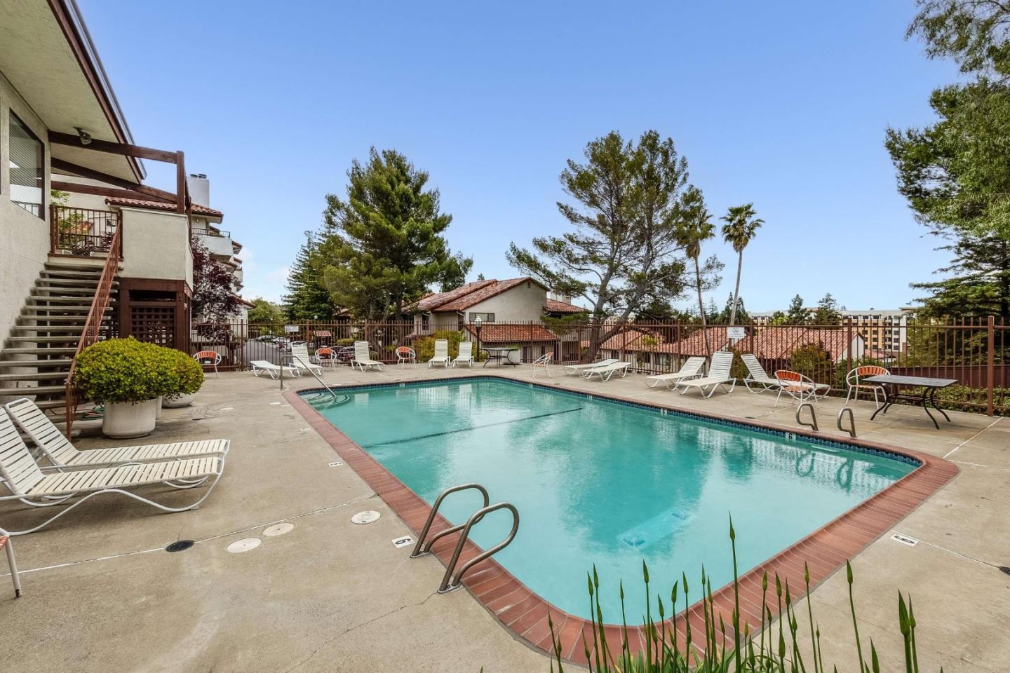 22135 Sevilla Road, Unit 47 Hayward, CA 94541 - Photo 32 of 37 a view of a swimming pool with a patio and plants