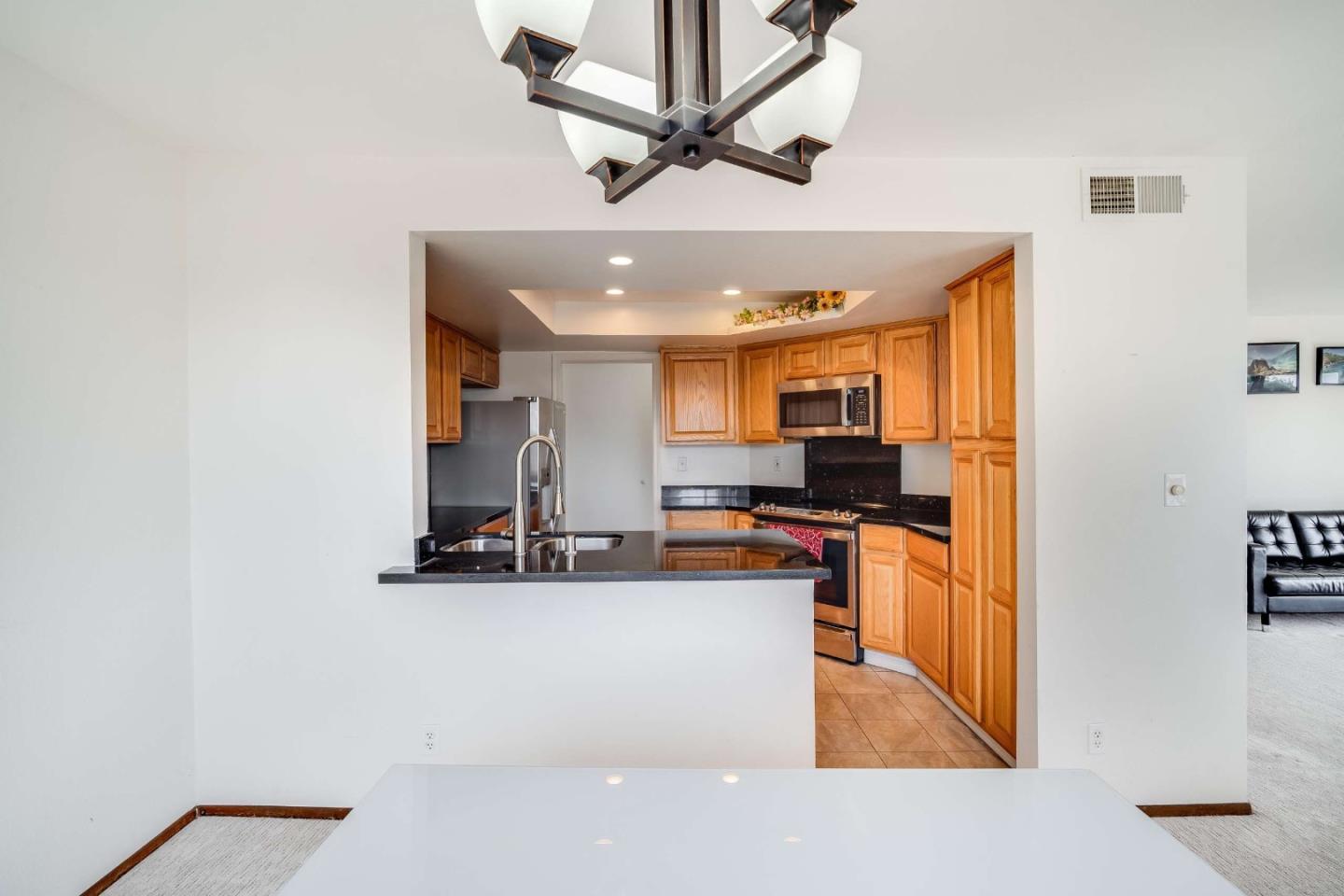 22135 Sevilla Road, Unit 47 Hayward, CA 94541 - Photo 9 of 37 a kitchen with stainless steel appliances granite countertop a refrigerator a stove and a sink