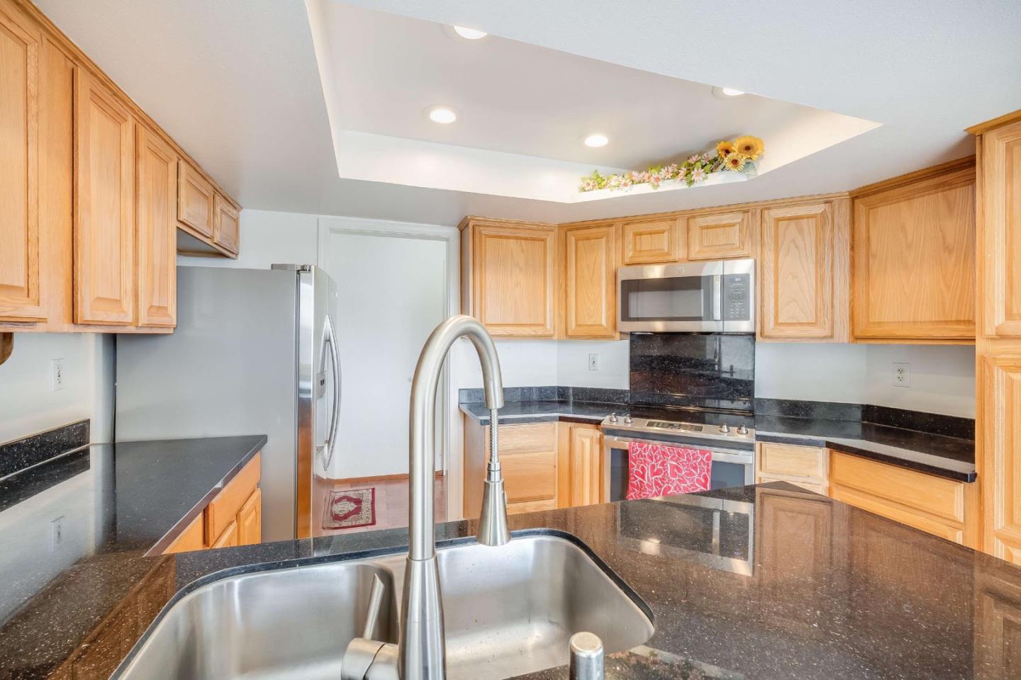 22135 Sevilla Road, Unit 47 Hayward, CA 94541 - Photo 10 of 37 a kitchen with stainless steel appliances granite countertop a sink and a microwave