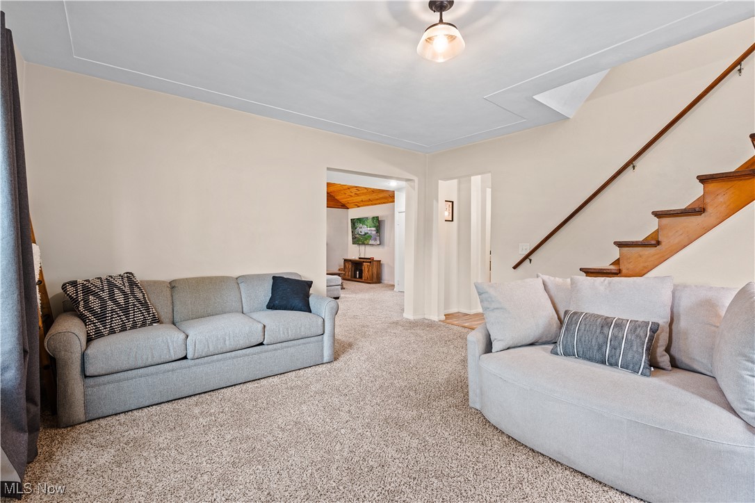 6170 Oberlin Road Amherst, OH 44001 - Photo 20 of 39 Carpeted living area with stairway