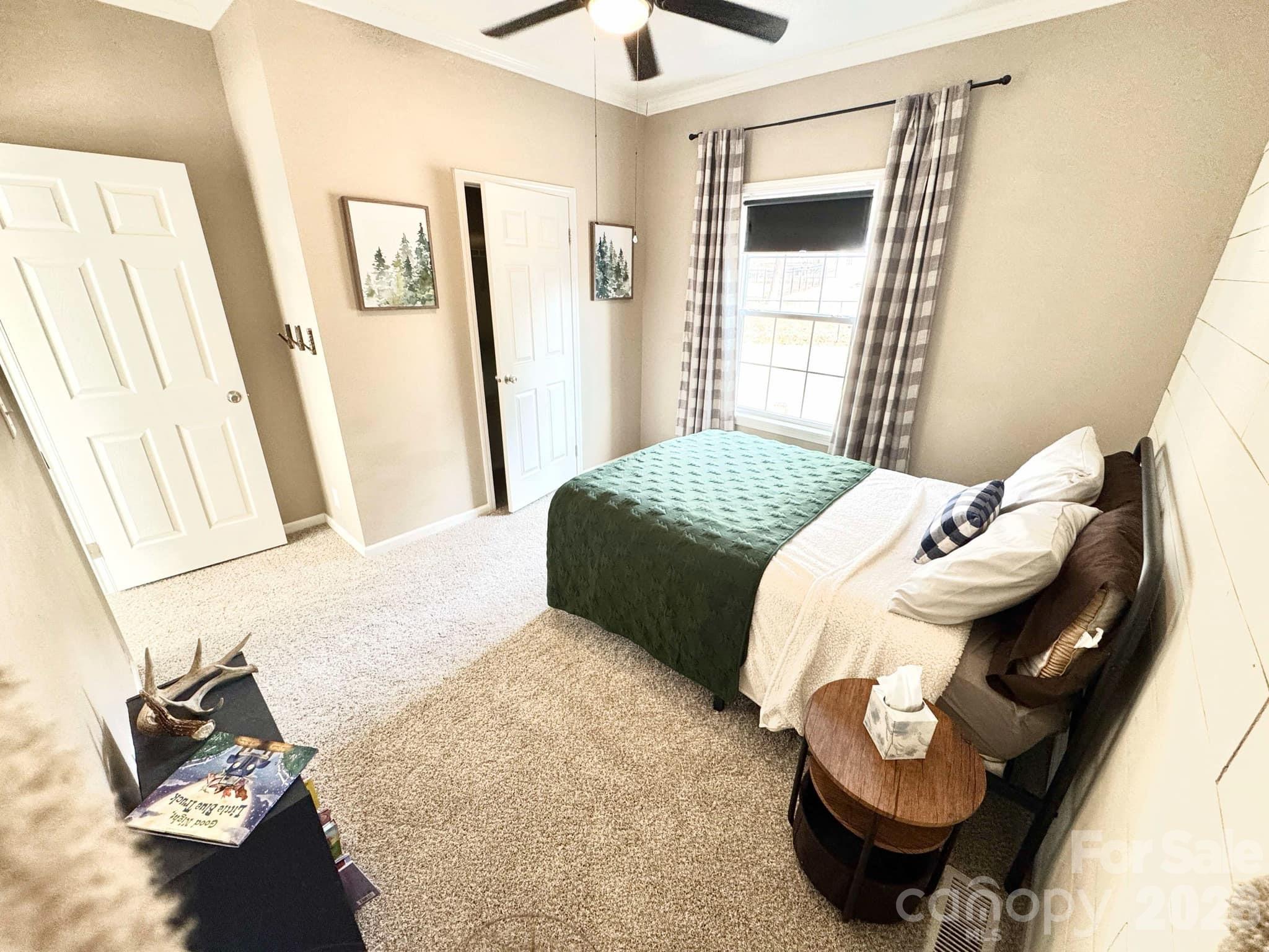 49428 Quail Trail Road Norwood, NC 28128 - Photo 11 of 13 a bedroom with a bed and wooden floor