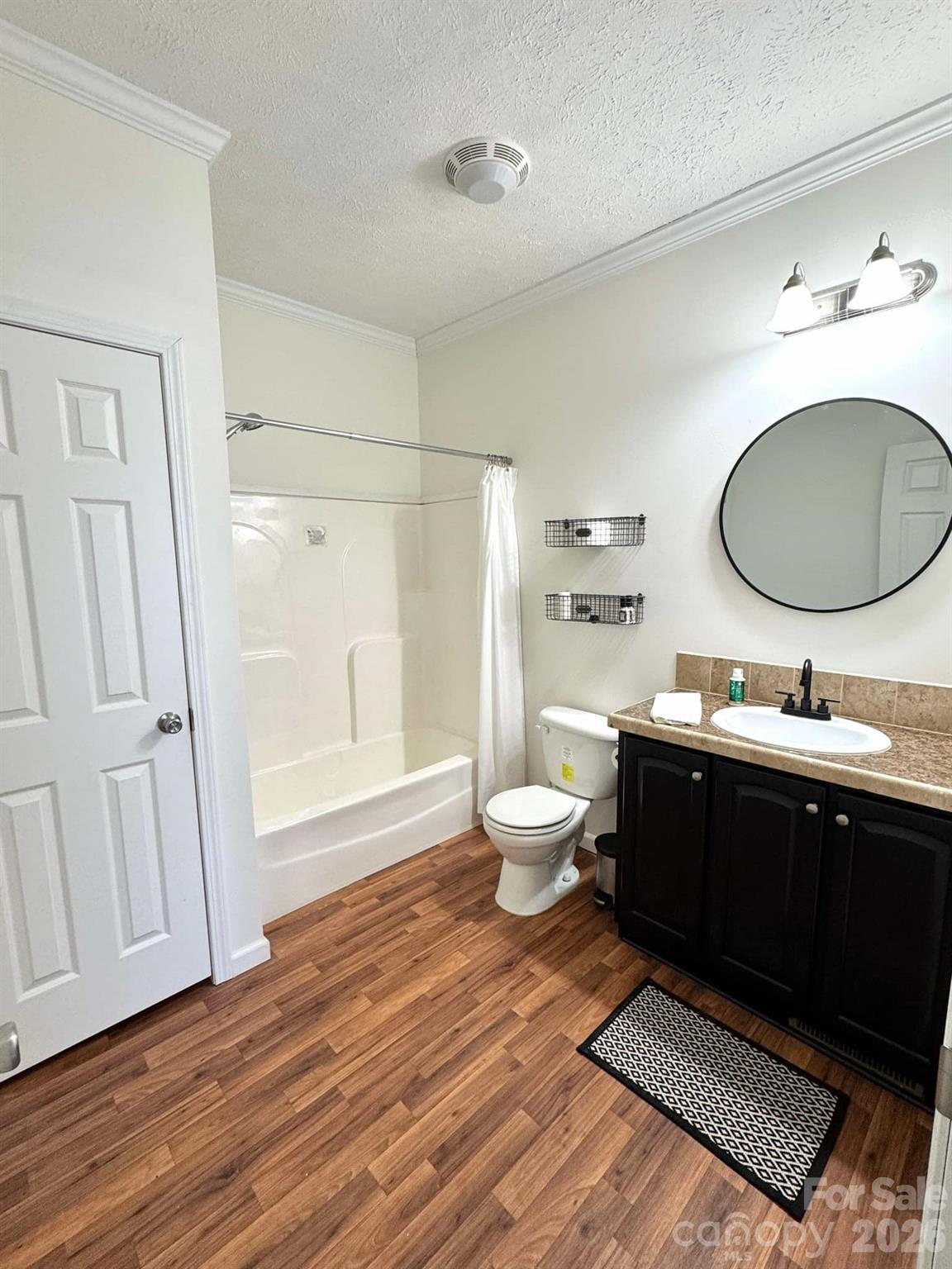 49428 Quail Trail Road Norwood, NC 28128 - Photo 12 of 13 a spacious bathroom with a granite countertop sink toilet and a mirror